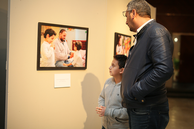 A Father and his Son During the Photo Exhibit 
