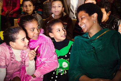 UN Women Executive Director Phumzile Mlambo-Ngcuka laughs with a group of young girls during a visit to one of UN Women’s Cairo Safe City programme sites on 3 February 2015. UN Women Egypt /Mohamed Ezz Aldin