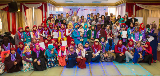 Women and girls who participated in Women's Empowerment Promotion Programme pose for a picture with key partners from UN Women, USAID, and CARE