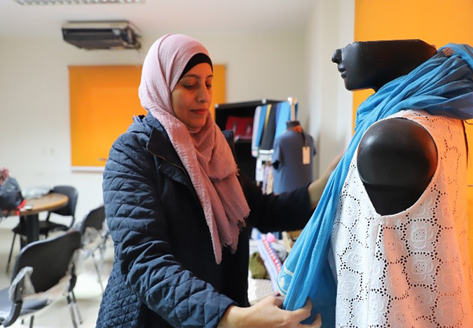 Fawzeya Ashraf adorns a mannequin with one of her creations. 
