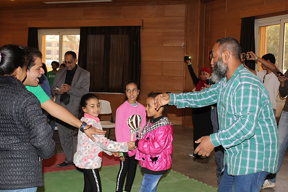 Araby Abdel-Aaty (right) dances with his daughters during the Father and Child Camp. 