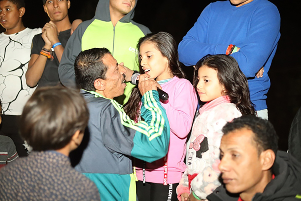Hany sings with his daughters during the Father and Child Camp. 