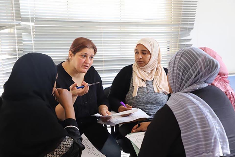 Elham, an Iraqi refugee, asks questions during the social counselling class. Photo: UN Women/Nada Ismail 