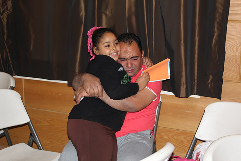 Mohamed Sayed hugs his daughter Nour with tears in his eyes during the Father and Child Camp. 