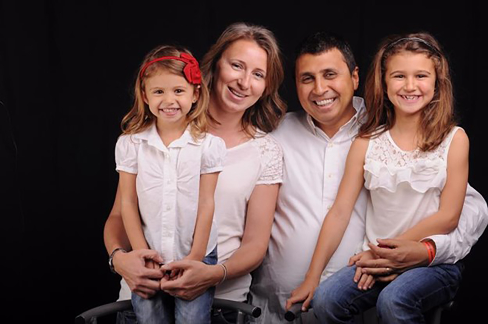 Maged Fawzy posing for a family photo with his wife and two daughters. Photo: Courtesy of Maged Fawzy 