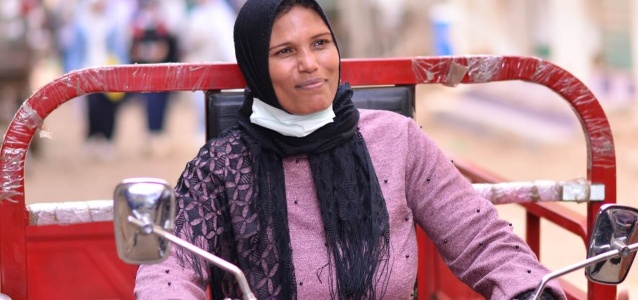Nora, one of the programme's beneficiaries on the tricycle that she bought to better distribute her products in Beni-Suef governorate. Photo: UN Women.